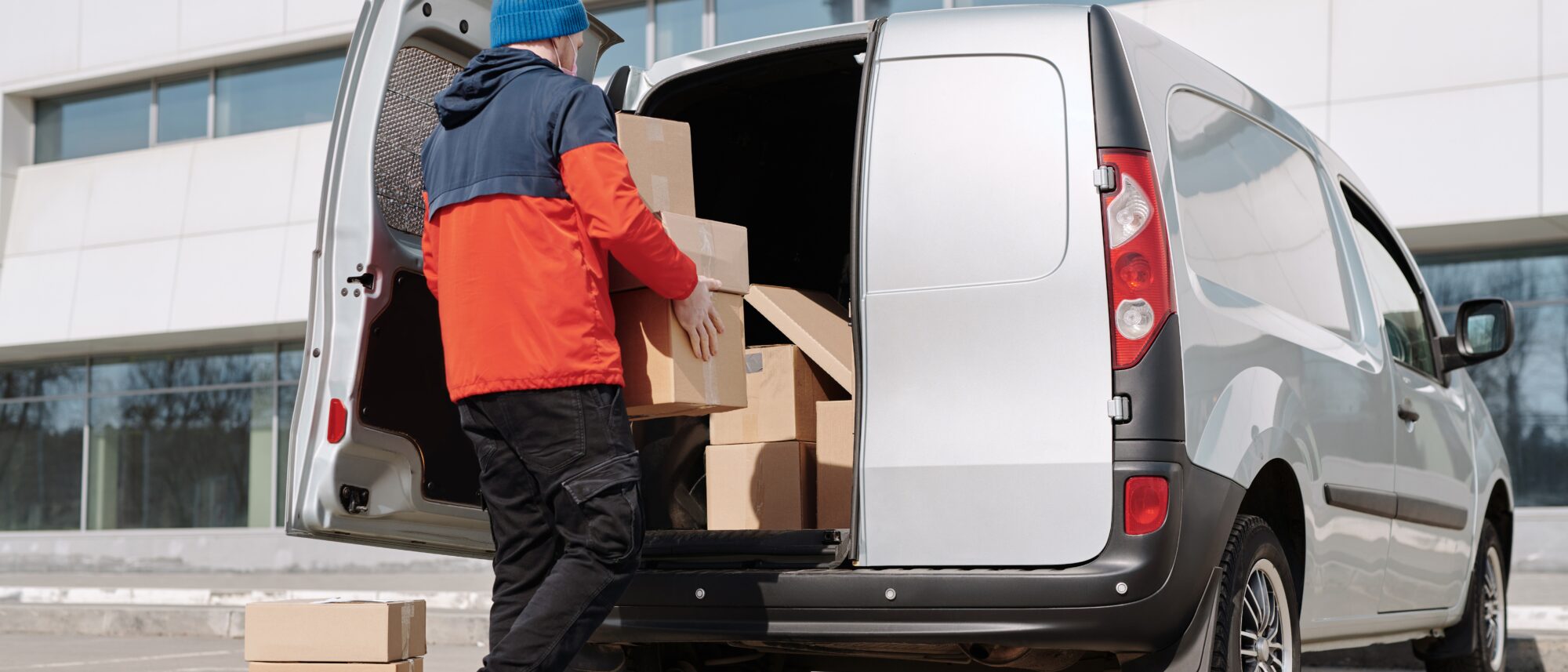 Man packing boxes into a van